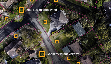 aerial shot of a suburb with address at entry location